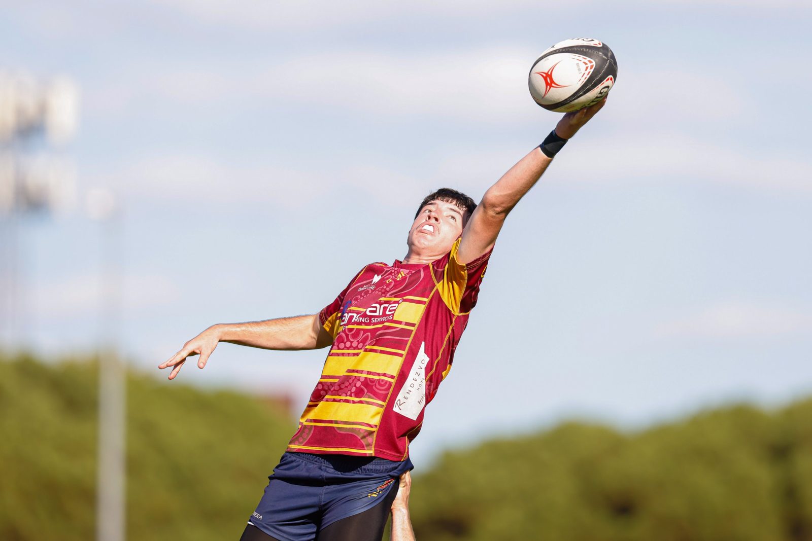 A Wests Colts player reaches high for a lineout ball